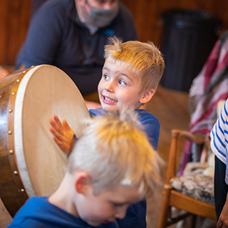 Picture of a child playing a Bodhran